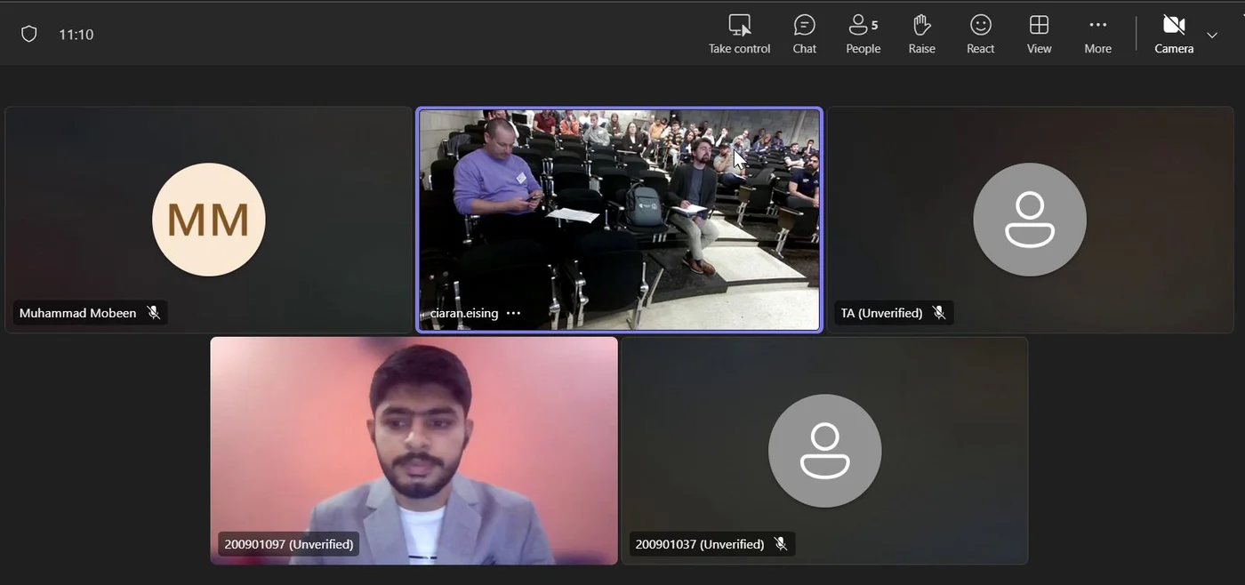The conference call in gallery view during the session. The largest tile is the room camera at the University of Limerick, showing a raked lecture theatre with attendees seated across several rows.